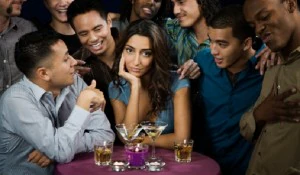 Multi-ethnic men talking to bored woman