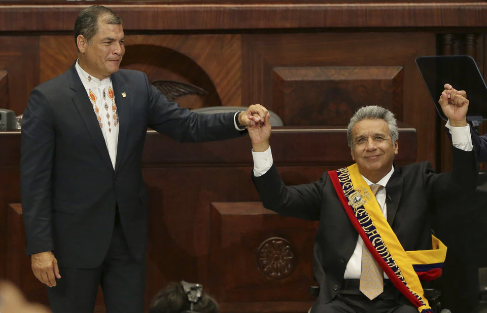Incoming President Lenin Moreno, wearing the Ecuadorian presidential sash, raises his hand with outgoing President Rafael Correa, during the swearing-in ceremony, in Quito, Ecuador, Wednesday, May 24, 2017. Moreno was sworn into office Wednesday after narrowly defeating a conservative former banker in last month’s runoff. (AP Photo/Dolores Ochoa)