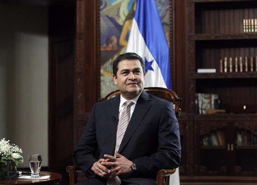 Honduran President Hernandez sits in his office during an interview with Reuters at the presidential palace in Tegucigalpa